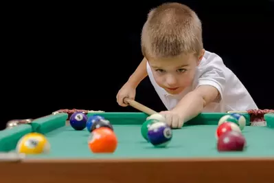 boy playing pool