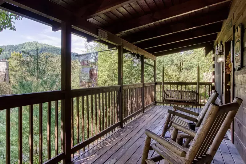 porch swing and rocking chairs on deck of Almost Heaven cabin