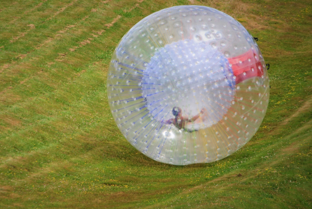 person zorbing in inflatable ball at Outdoor Gravity Park