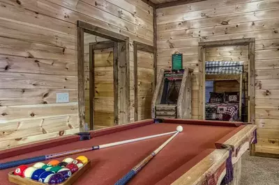 pool table and arcade game in game room at Bearly Believe It