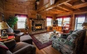 The living room of a Pigeon Forge cabin rental with a fireplace.