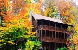The Renewed Spirit cabin surrounded by fall foliage at Eagles Ridge Resort in Pigeon Forge TN.