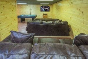 Comfortable sofas in a theater room in a Pigeon Forge cabin.
