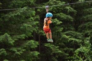 child ziplining in the mountains