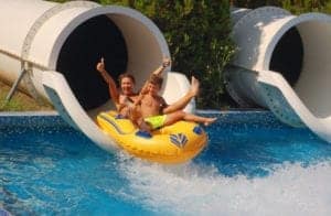 people coming out of a waterslide