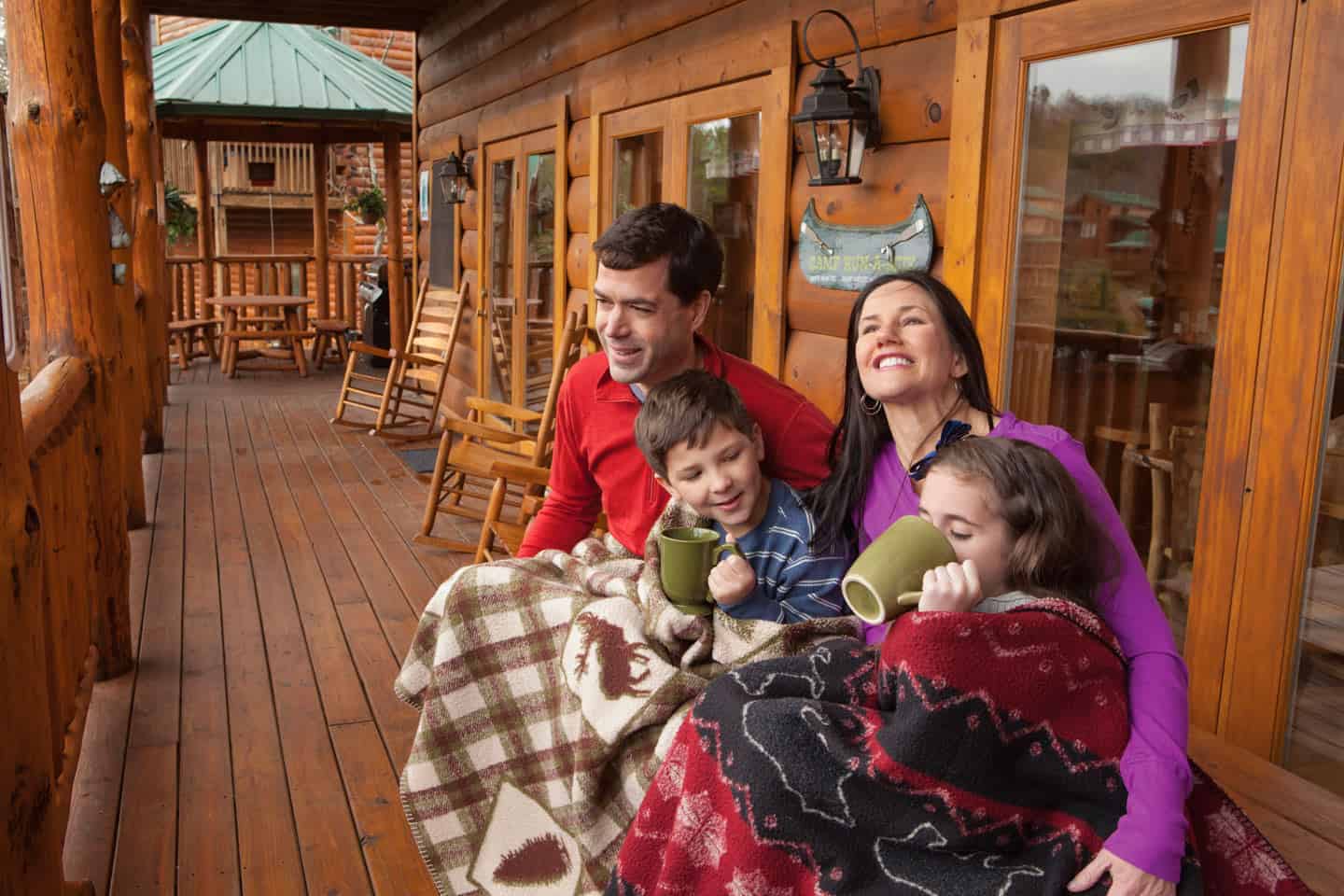 family sitting on cabin deck