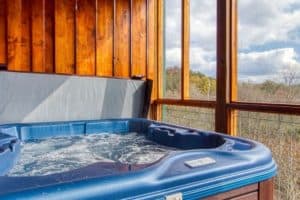 hot tub at bearly cabin with trees in background for a Pigeon Forge cabin vacation